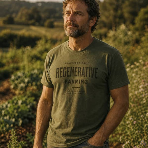 Regenerative Farming organic cotton t-shirt worn by man in a regenerative farm field at golden hour