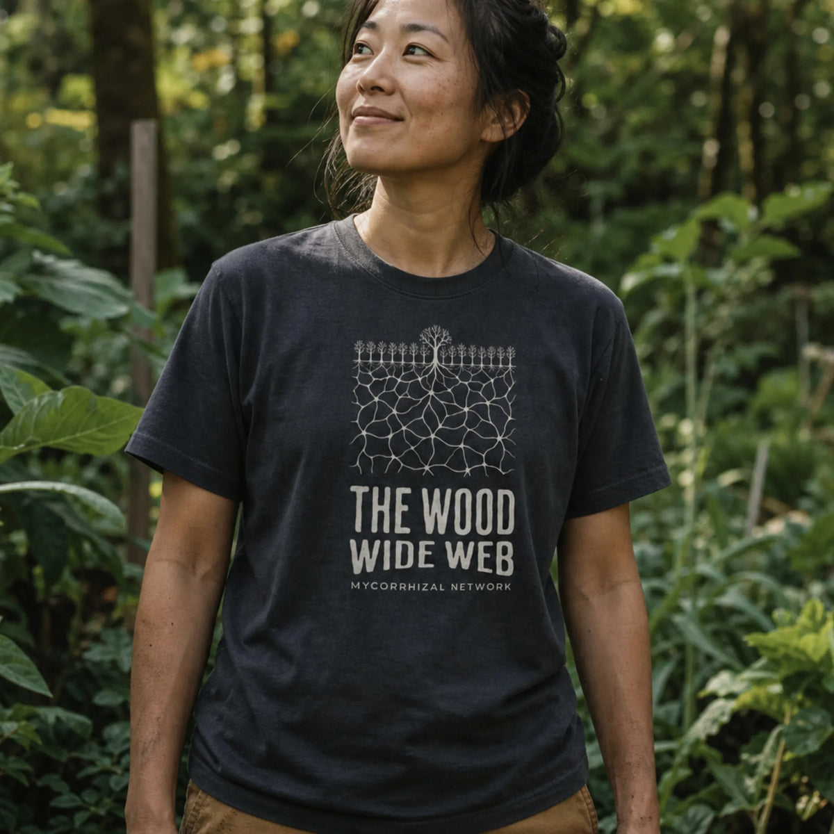 Mycorrhizal Network organic cotton t-shirt worn by woman in a biodiverse permaculture garden