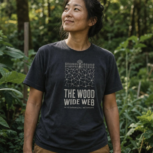Mycorrhizal Network organic cotton t-shirt worn by woman in a biodiverse permaculture garden