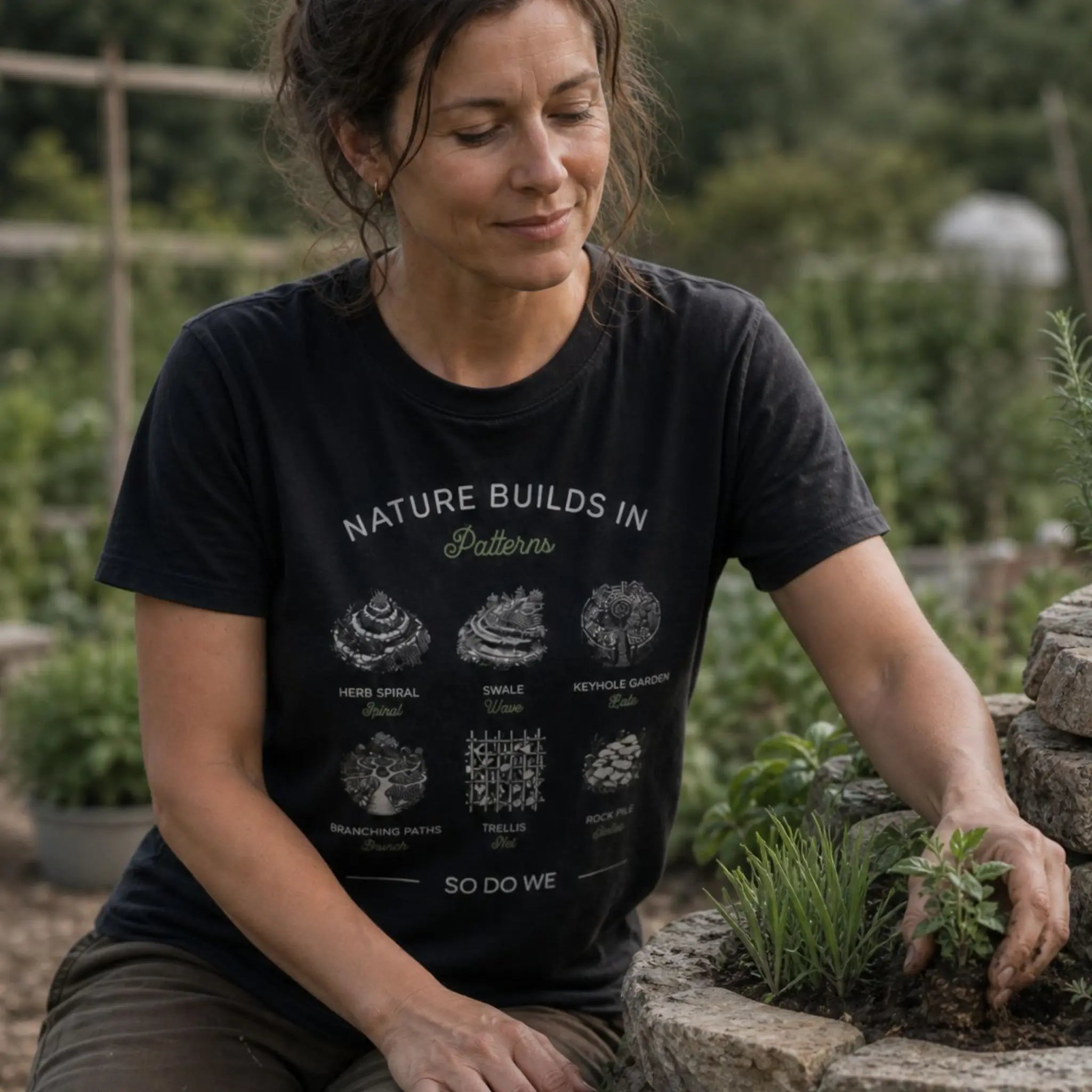 Permaculture in Patterns organic cotton t-shirt worn by woman planting a herb spiral.