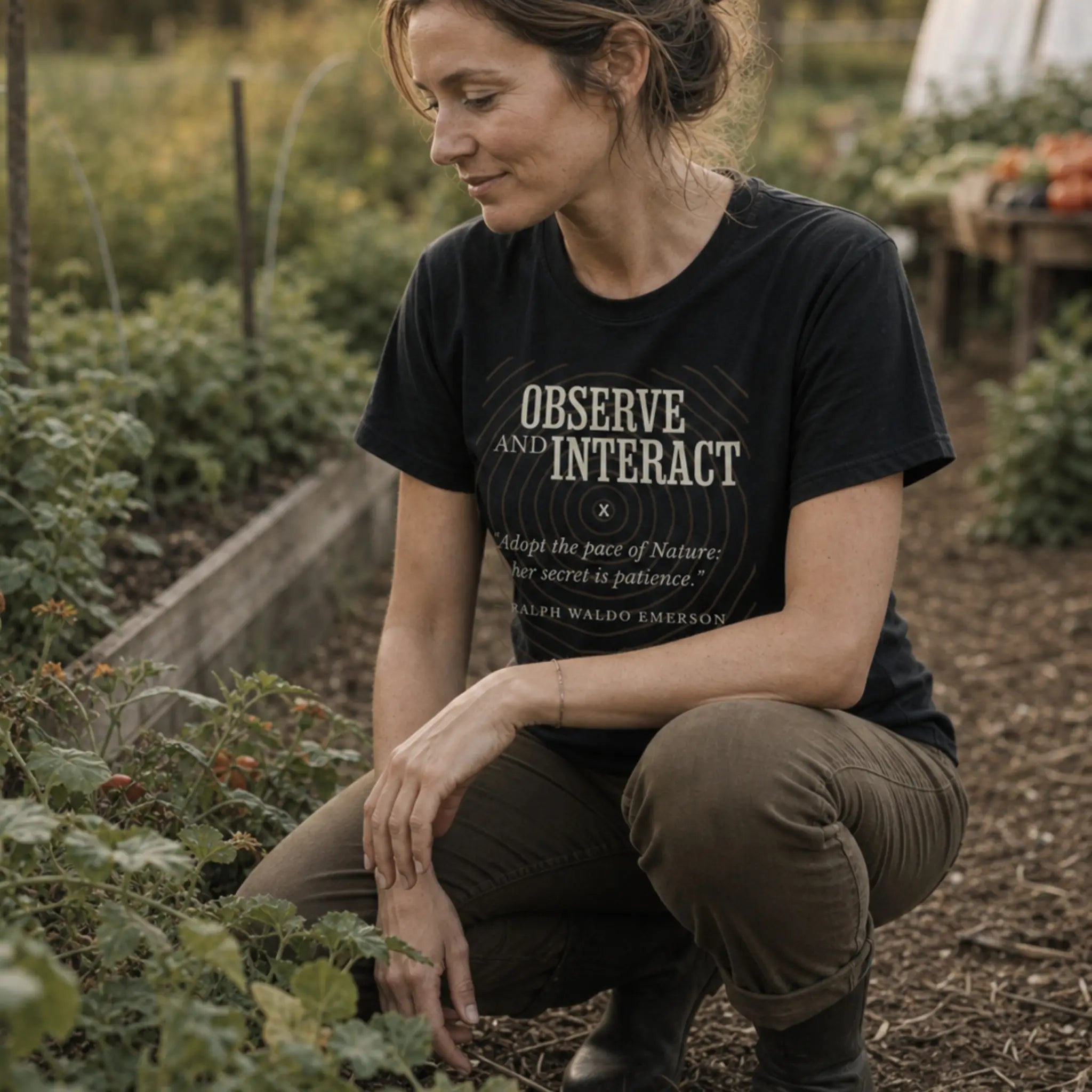 Observe and Interact organic cotton t-shirt worn by woman quietly observing a regenerative landscape