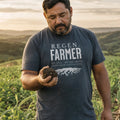 Regenerative Farmer organic cotton t-shirt worn by man assessing soil health in a no-till field with cover crops